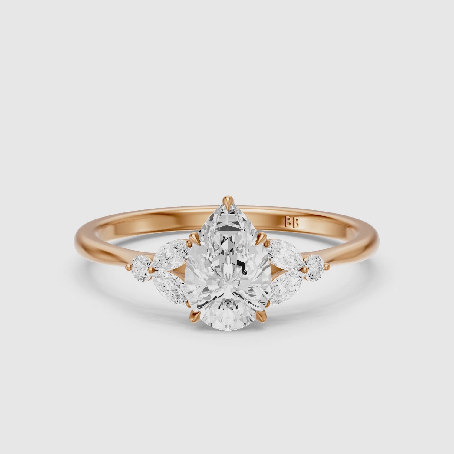 Load video: Liora Pear Cut Moissanite Diamond Ring with Marquise Side Stone Cluster