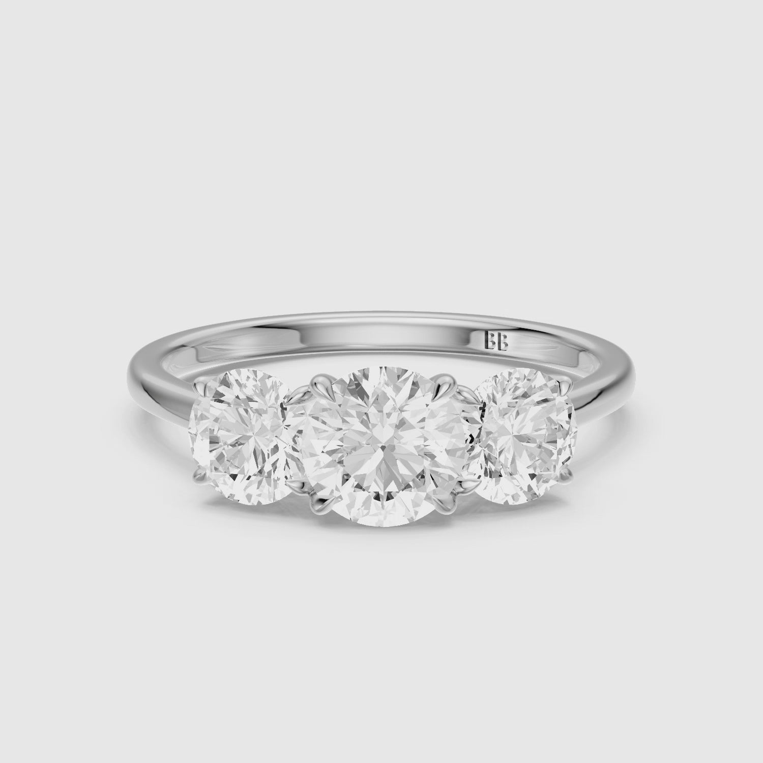 Load video: Kassie Round Cut Three Stone Cathedral Style Lab Grown Diamond Ring