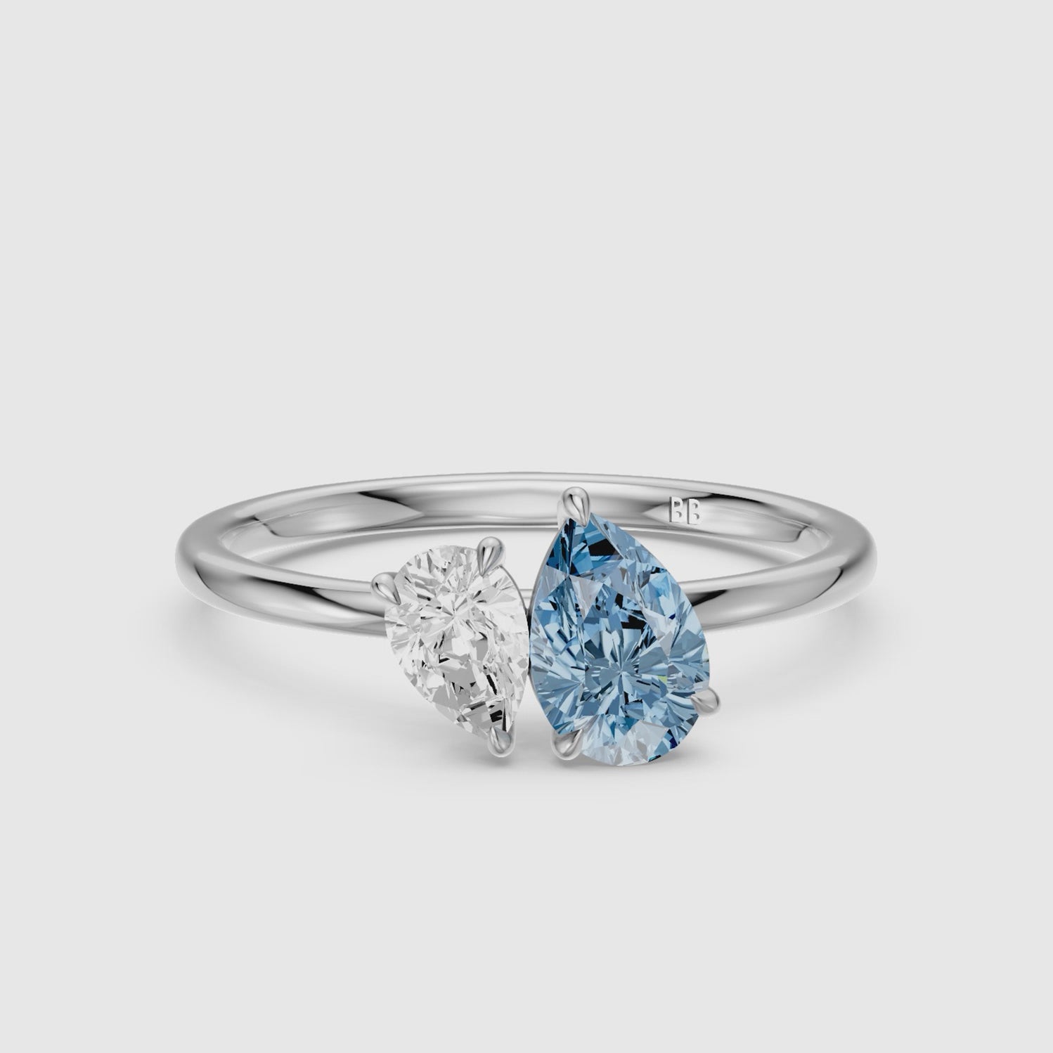 Load video: Livia Blue and White Graduated Pear Shape Color Lab Grown Diamond Toi et Moi Ring