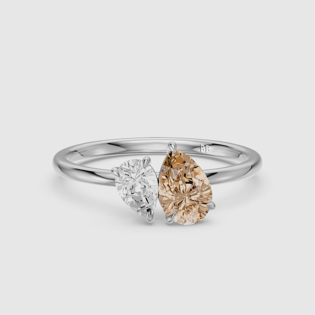 Load video: Fenna Champagne and White Graduated Pear Shape Color Lab Grown Diamond Toi et Moi Ring