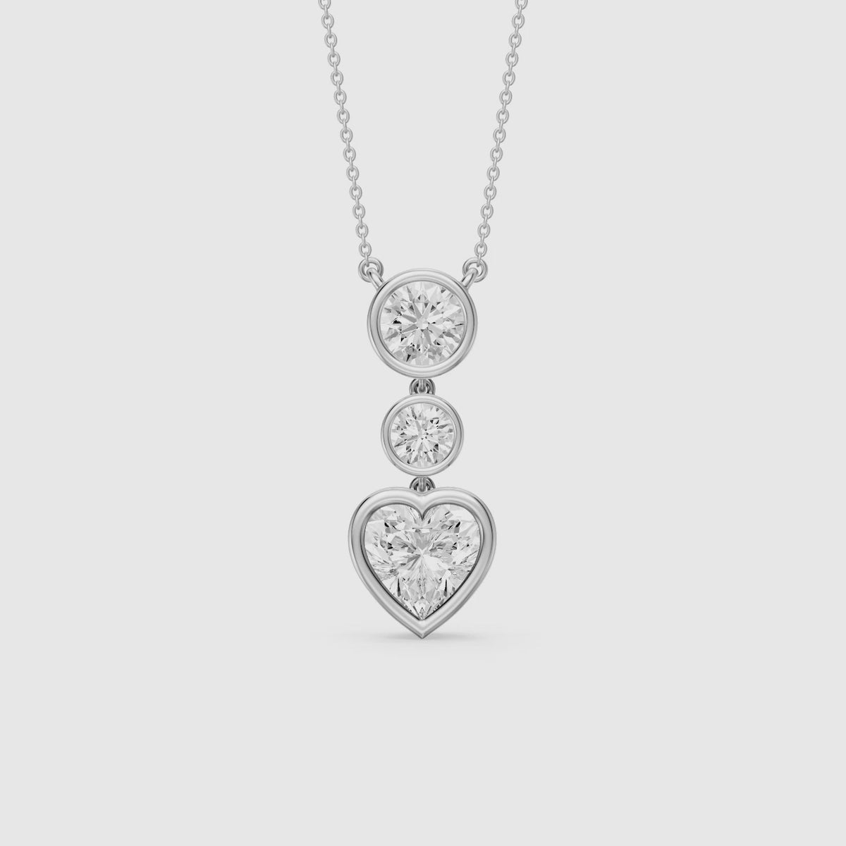 Load video: Ivory Heart Shape and Round Lab Grown Diamond Bezel Drop Pendant