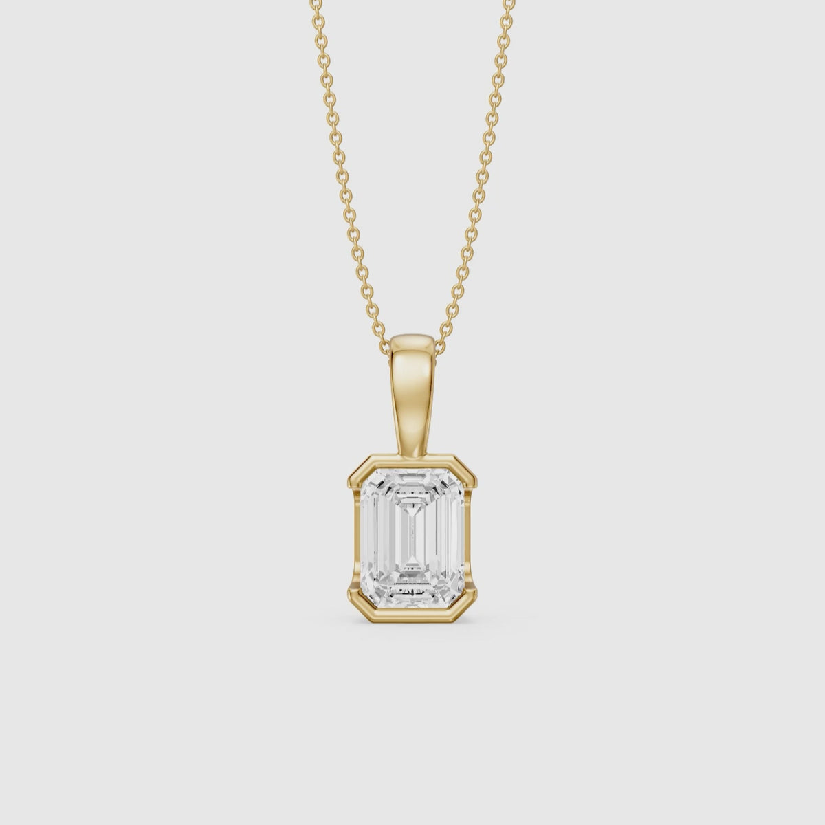 Load video: Catherine Emerald Cut Lab Grown Diamond Half Bezel Pendant