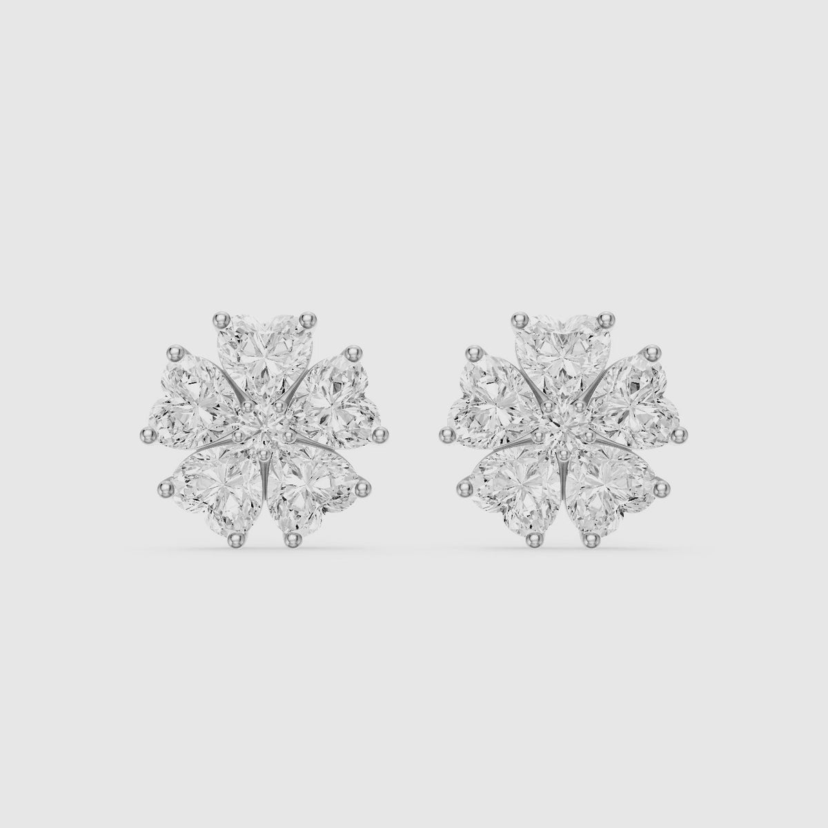 Load video: Zinnia Heart Shape Lab Grown Diamond Five Petal Flower Cluster Stud Earrings