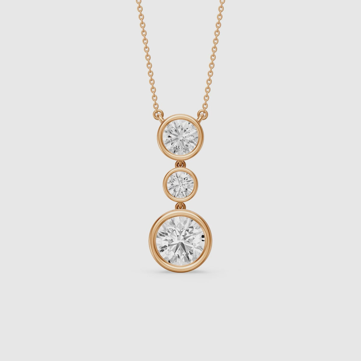 Load video: Esmeralda Three Stone Round Bezel Lab Grown Diamond Pendant