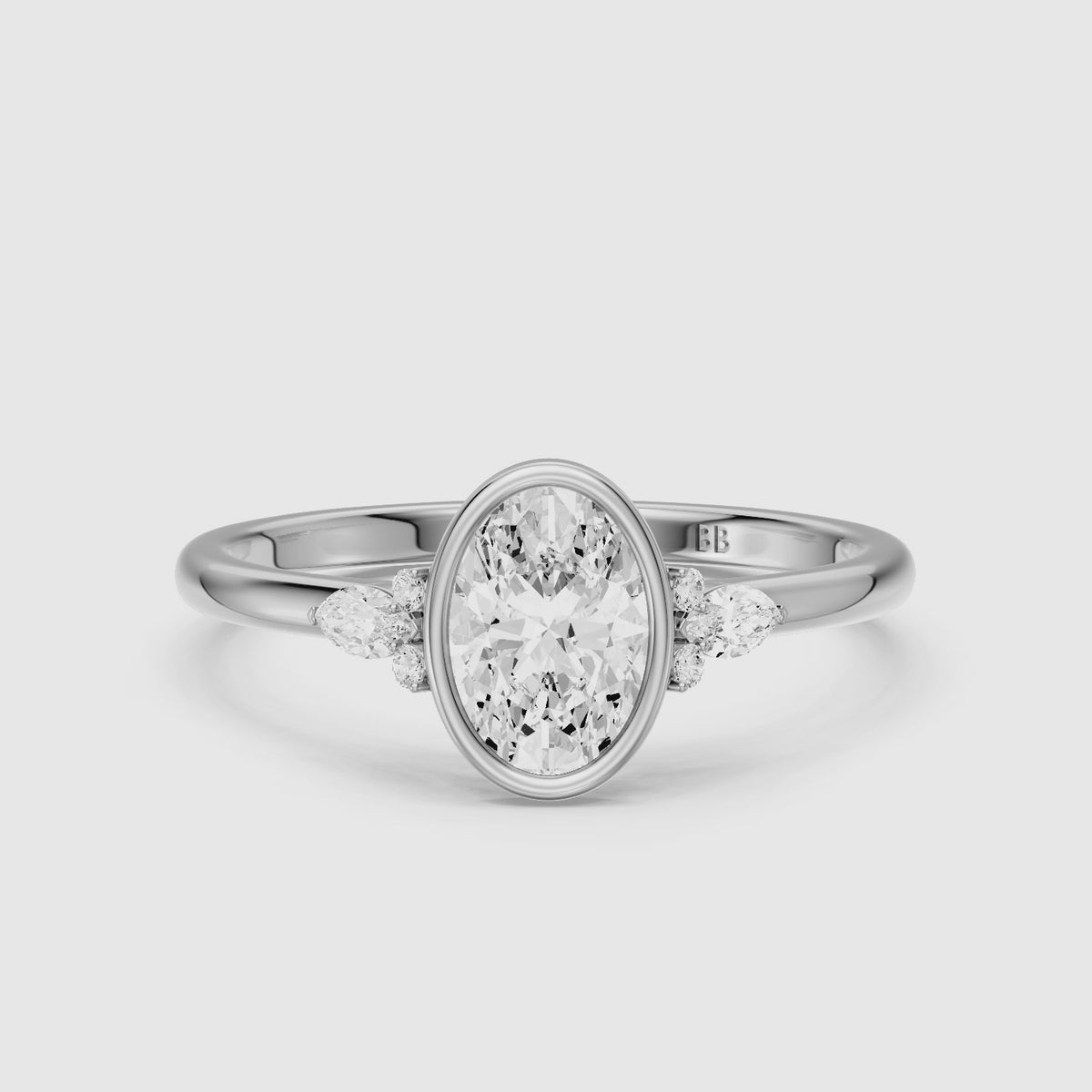 Load video: Lumi Oval Cut Bezel Lab Grown Diamond Engagement Ring with Pear Side Stones
