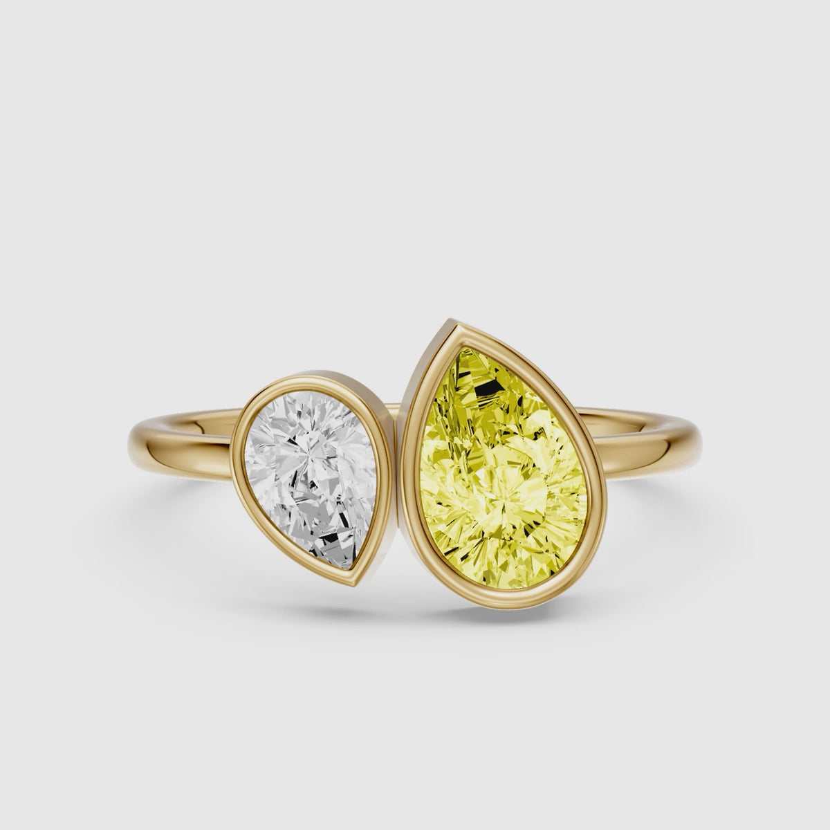 Load video: Fiora Yellow and White Pear Cut Colored Lab Grown Diamond Toi et Moi Bezel Ring