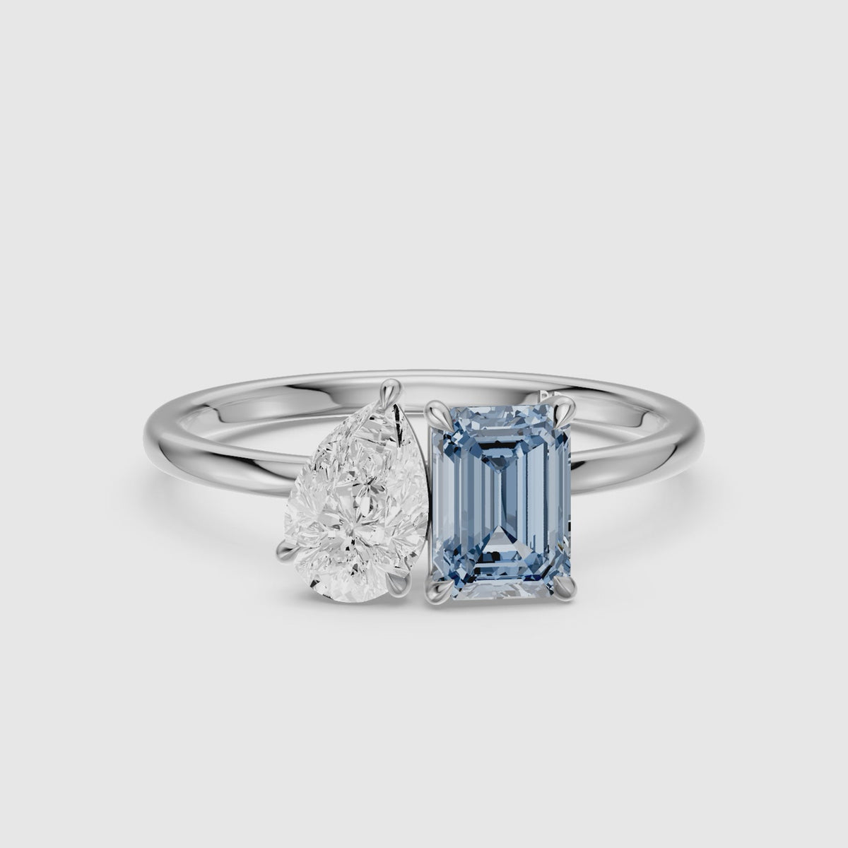 Load video: Runa Blue Emerald Cut and Pear Shape Color Lab Grown Diamond Toi et Moi Ring