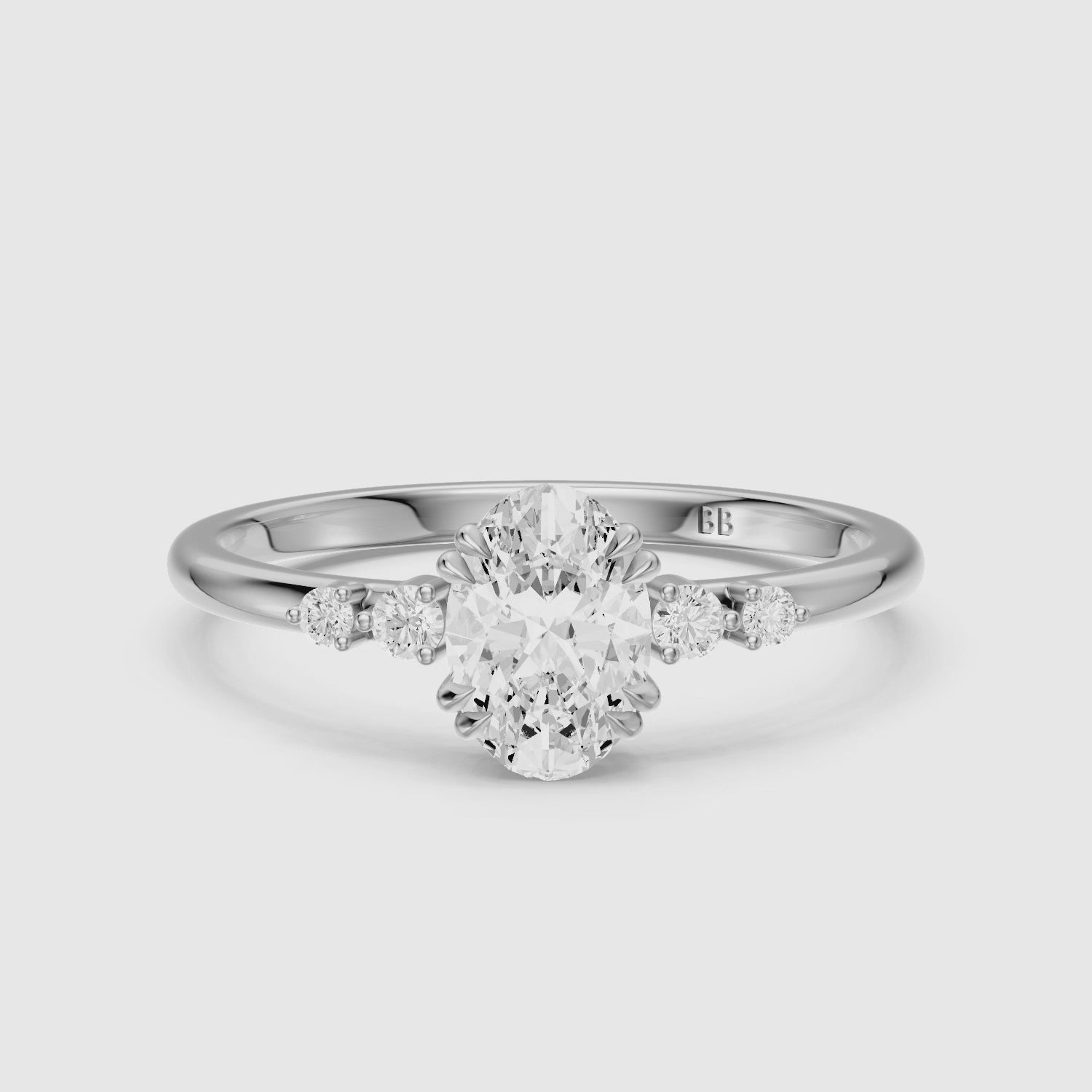 Load video: Lucille Oval Double Claw Prong Moissanite Diamond Ring with Side Stones