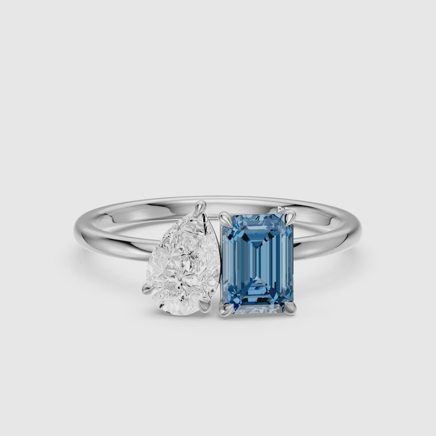 Load video: Runa Blue Emerald Cut and Pear Shape Color Lab Grown Diamond Toi et Moi Ring
