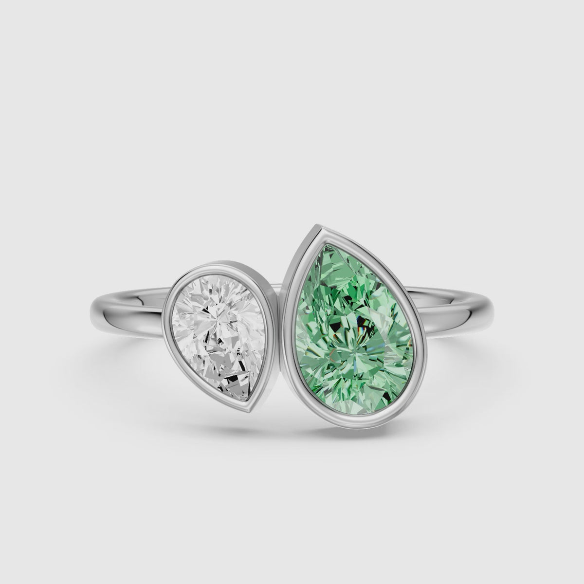 Load video: Oriana Green and White Pear Cut Colored Lab Grown Diamond Toi et Moi Bezel Ring