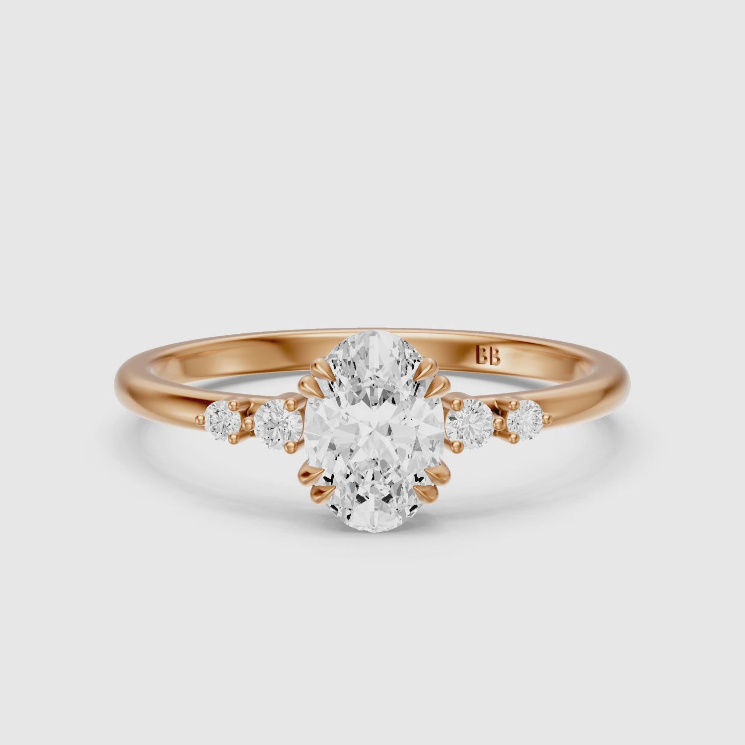 Load video: Lucille Oval Double Claw Prong Moissanite Diamond Ring with Side Stones