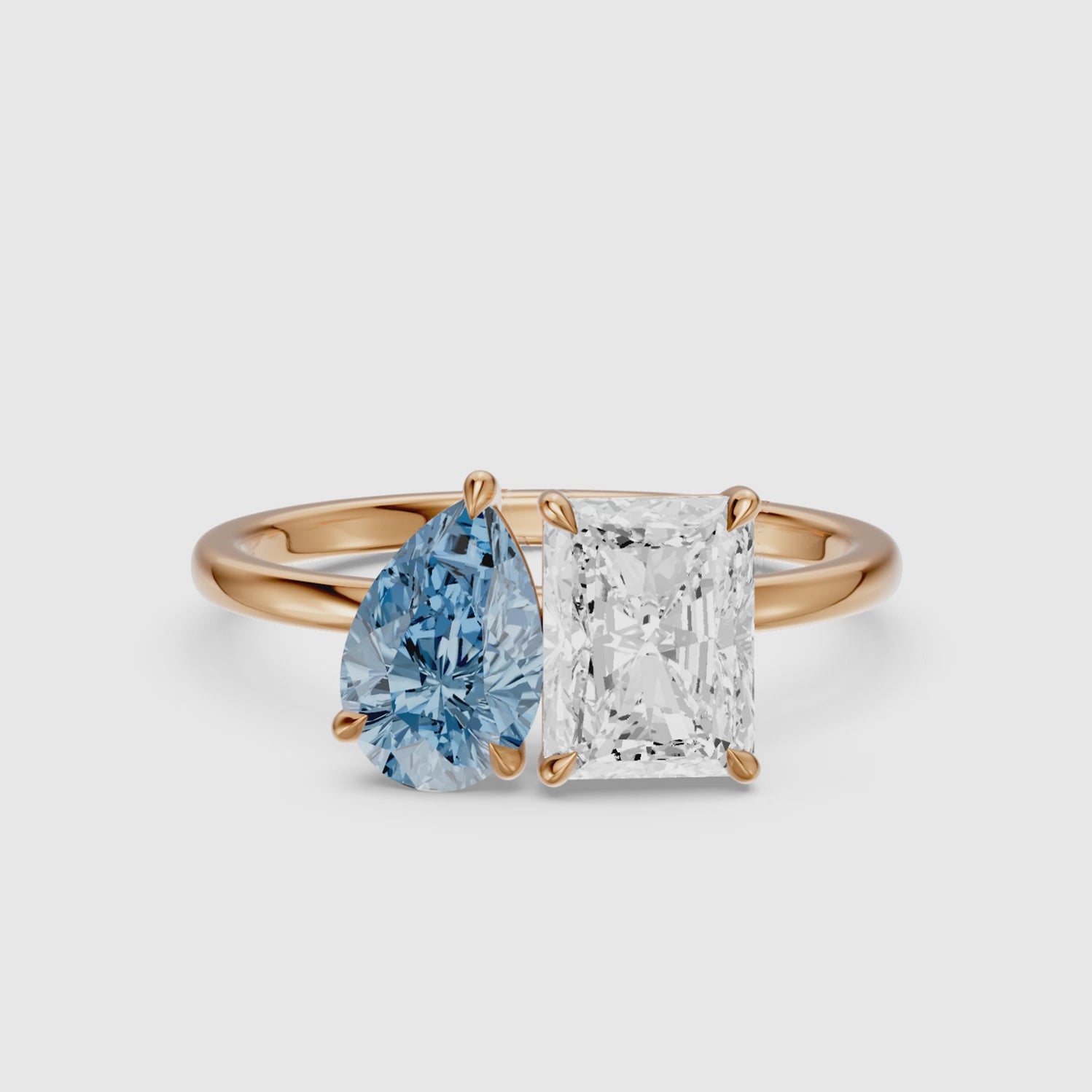 Load video: Eulalia Blue Pear and Radiant Cut Colored Lab Grown Diamond Toi et Moi Ring