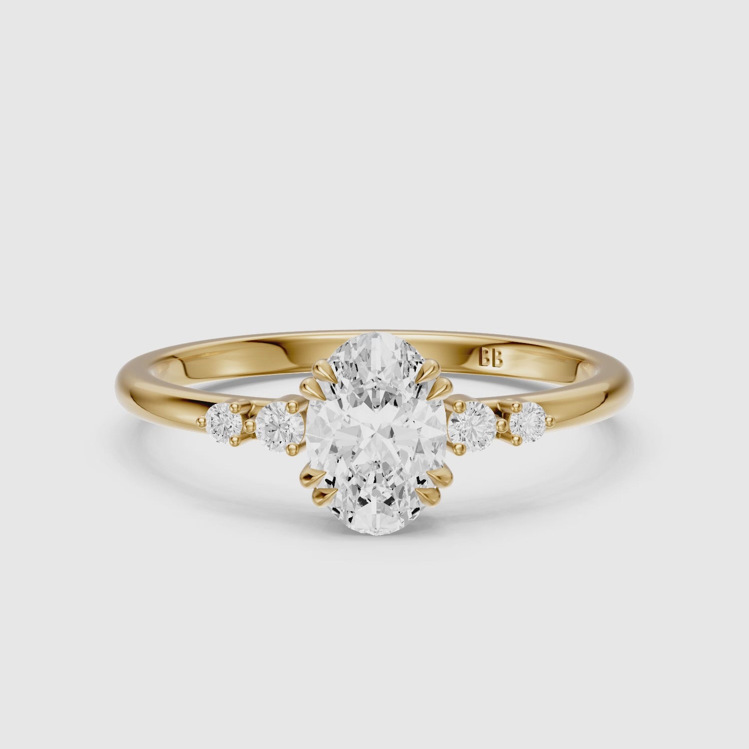 Load video: Lucille Oval Double Claw Prong Moissanite Diamond Ring with Side Stones