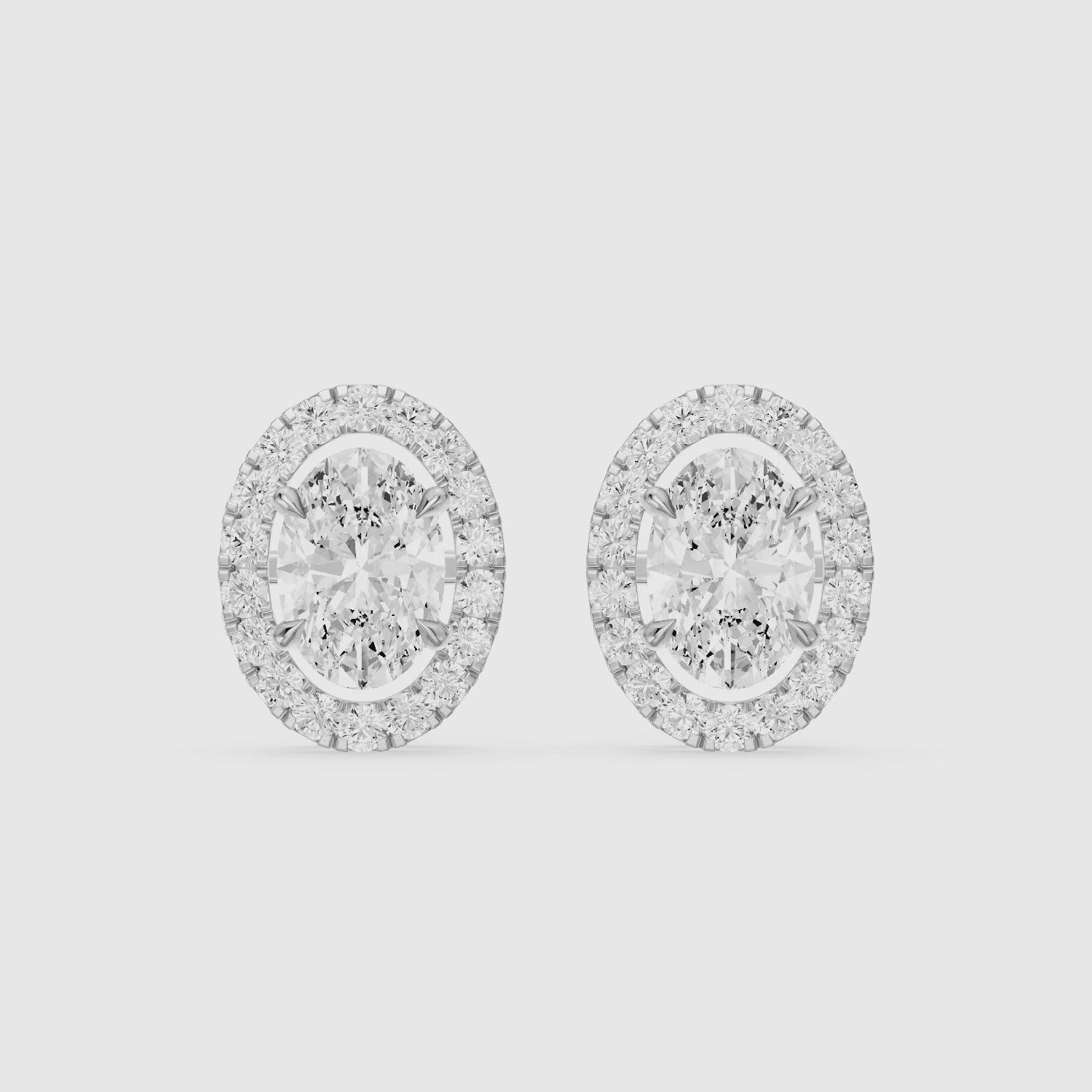 Load video: Vaida Oval Cut Lab Grown Diamond Halo Stud Earrings