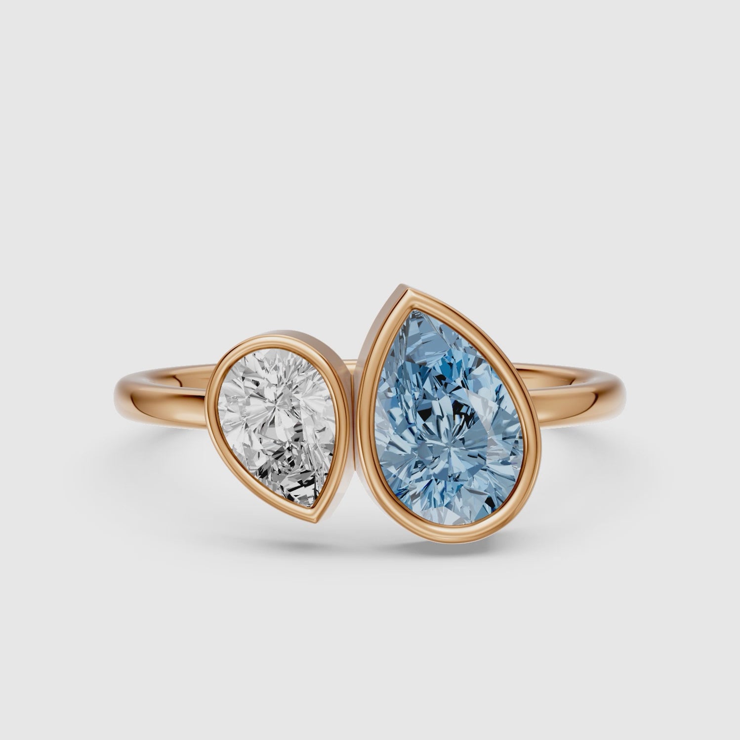 Load video: Nicolina Blue and White Pear Cut Colored Lab Grown Diamond Toi et Moi Bezel Ring