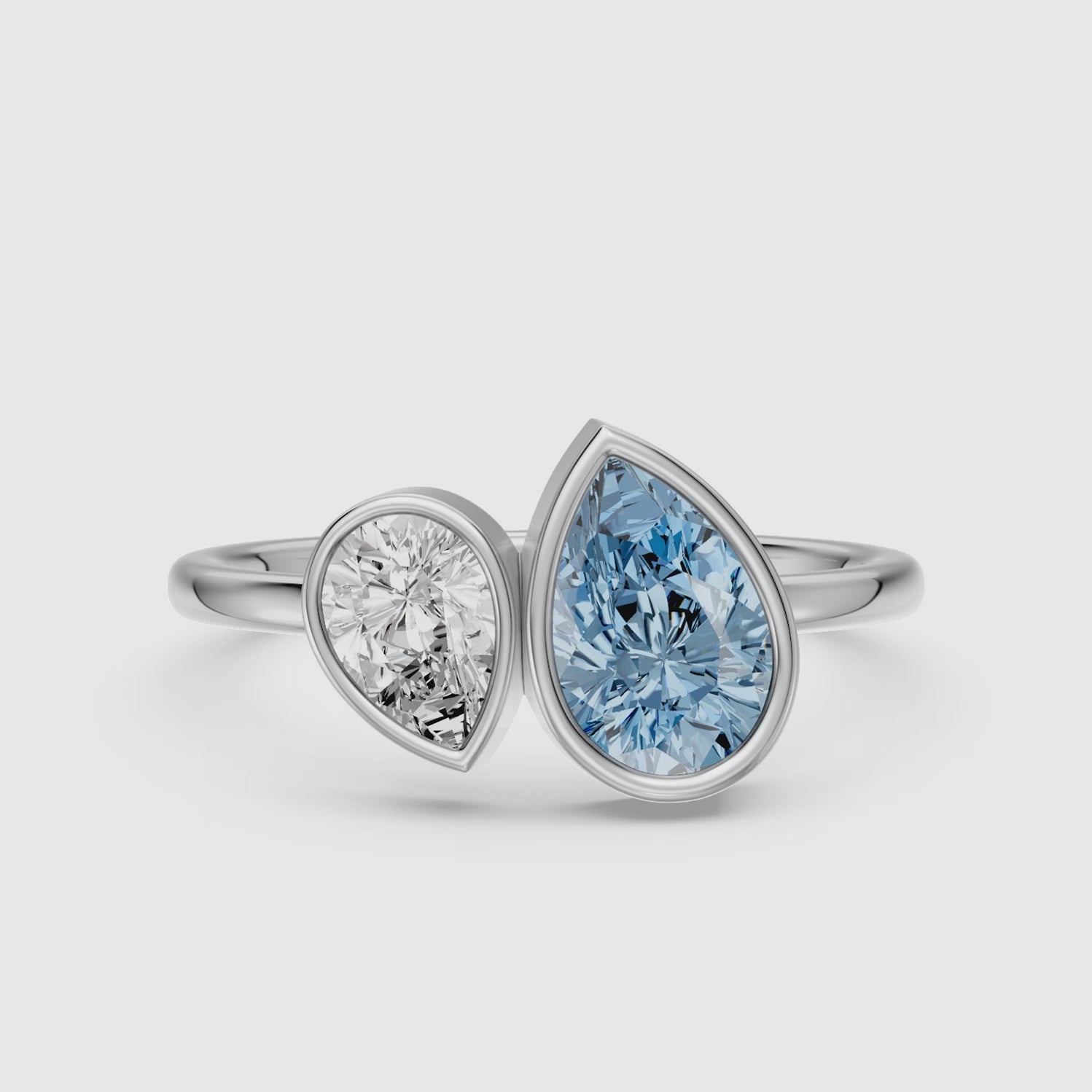 Load video: Nicolina Blue and White Pear Cut Colored Lab Grown Diamond Toi et Moi Bezel Ring