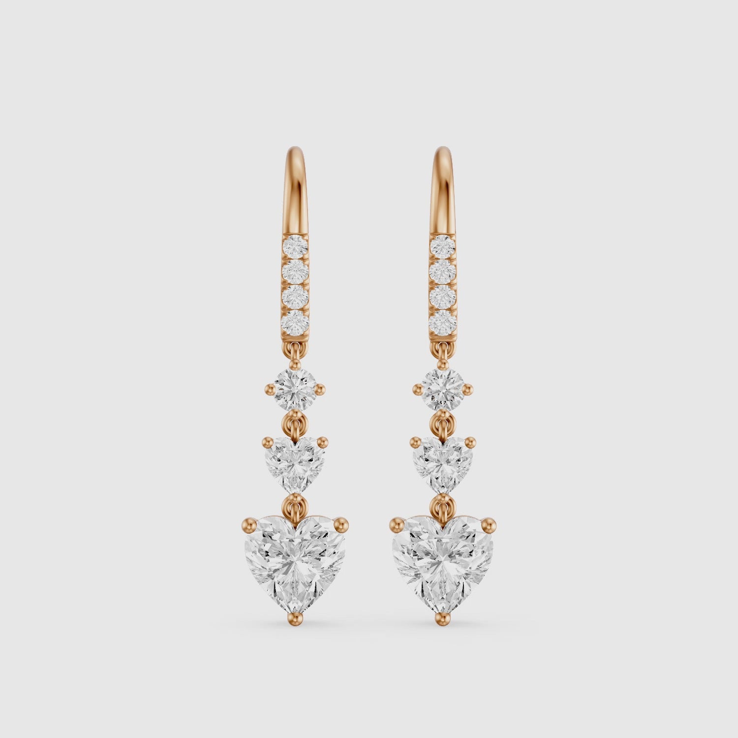 Load video: Yasmin Graduated Heart and Round Lab Grown Diamond Dangle Earrings