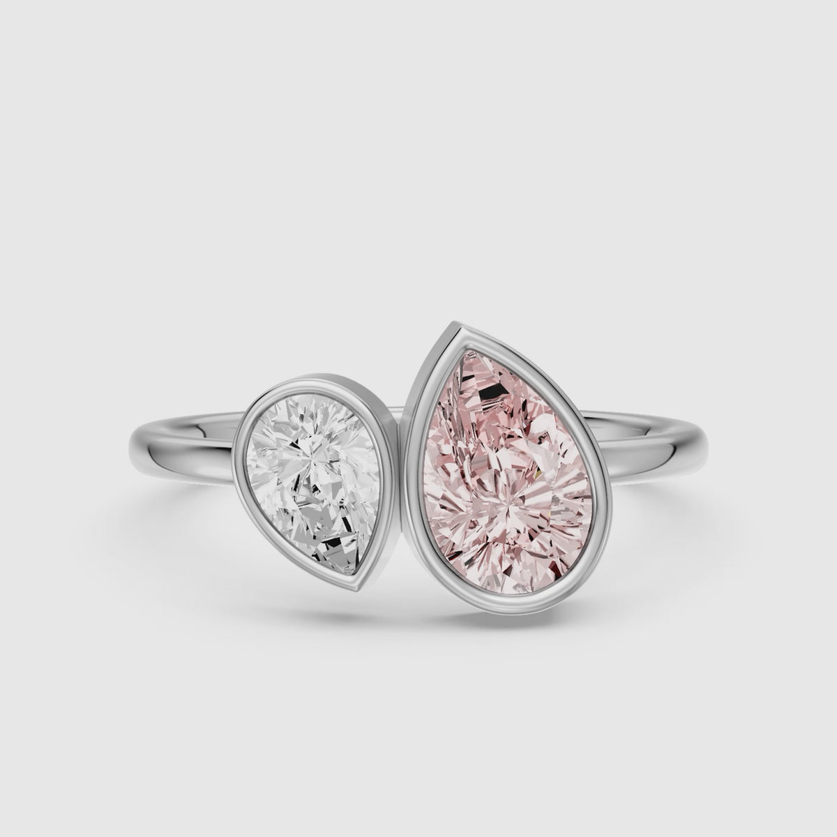Load video: Prisca Pink and White Pear Cut Colored Lab Grown Diamond Toi et Moi Bezel Ring