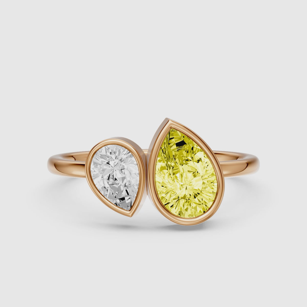 Load video: Fiora Yellow and White Pear Cut Colored Lab Grown Diamond Toi et Moi Bezel Ring