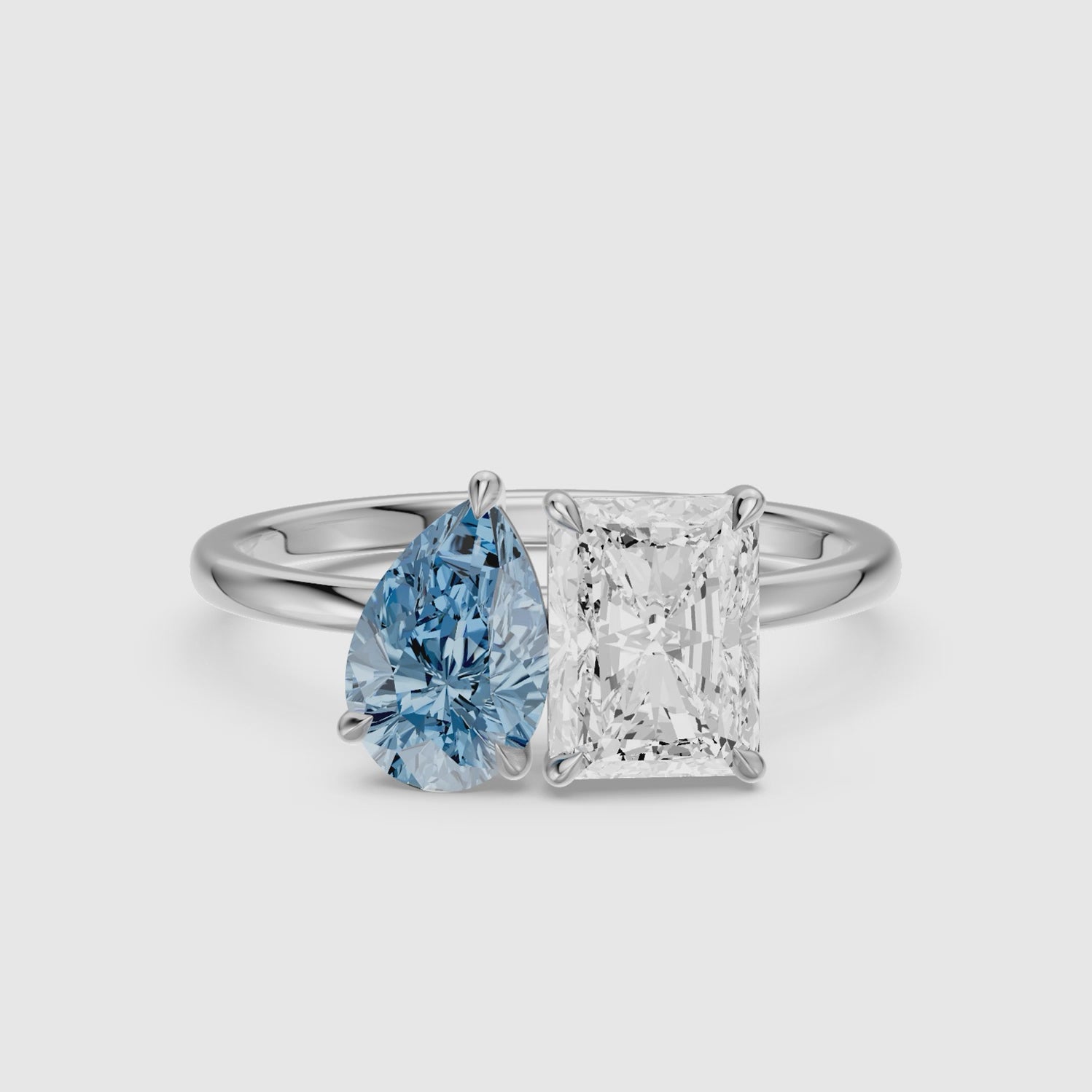 Load video: Eulalia Blue Pear and Radiant Cut Colored Lab Grown Diamond Toi et Moi Ring