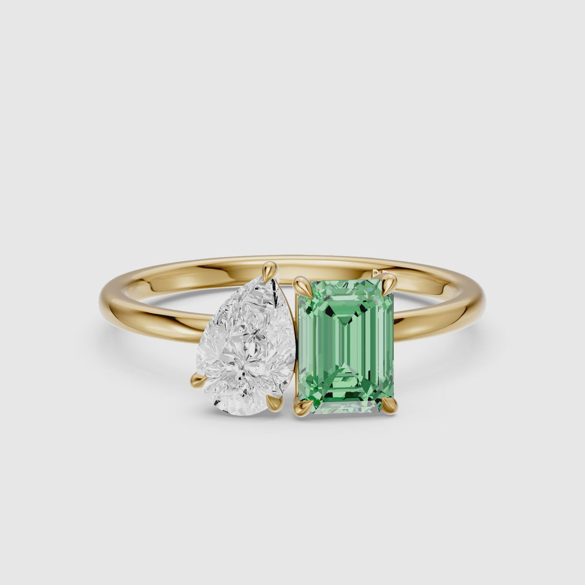 Load video: Belle Green Emerald Cut and Pear Shape Color Lab Grown Diamond Toi et Moi Ring