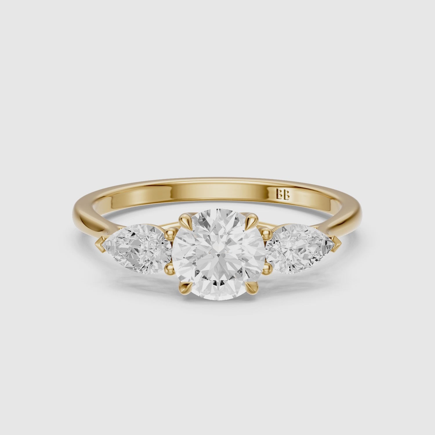Load video: Emmill Three Stone Round Cut Lab Grown Diamond Ring WIth Pear Side Stone