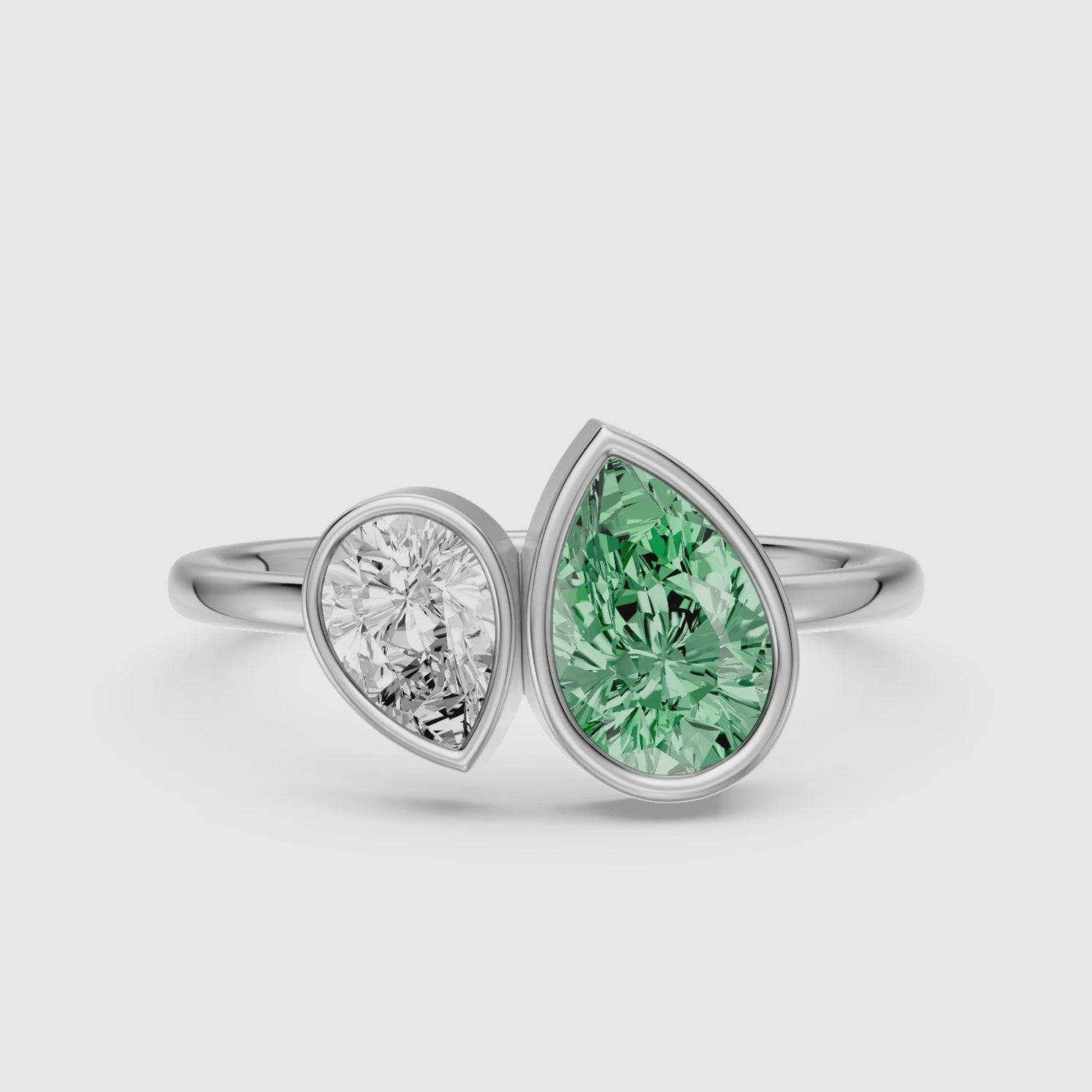 Load video: Oriana Green and White Pear Cut Colored Lab Grown Diamond Toi et Moi Bezel Ring