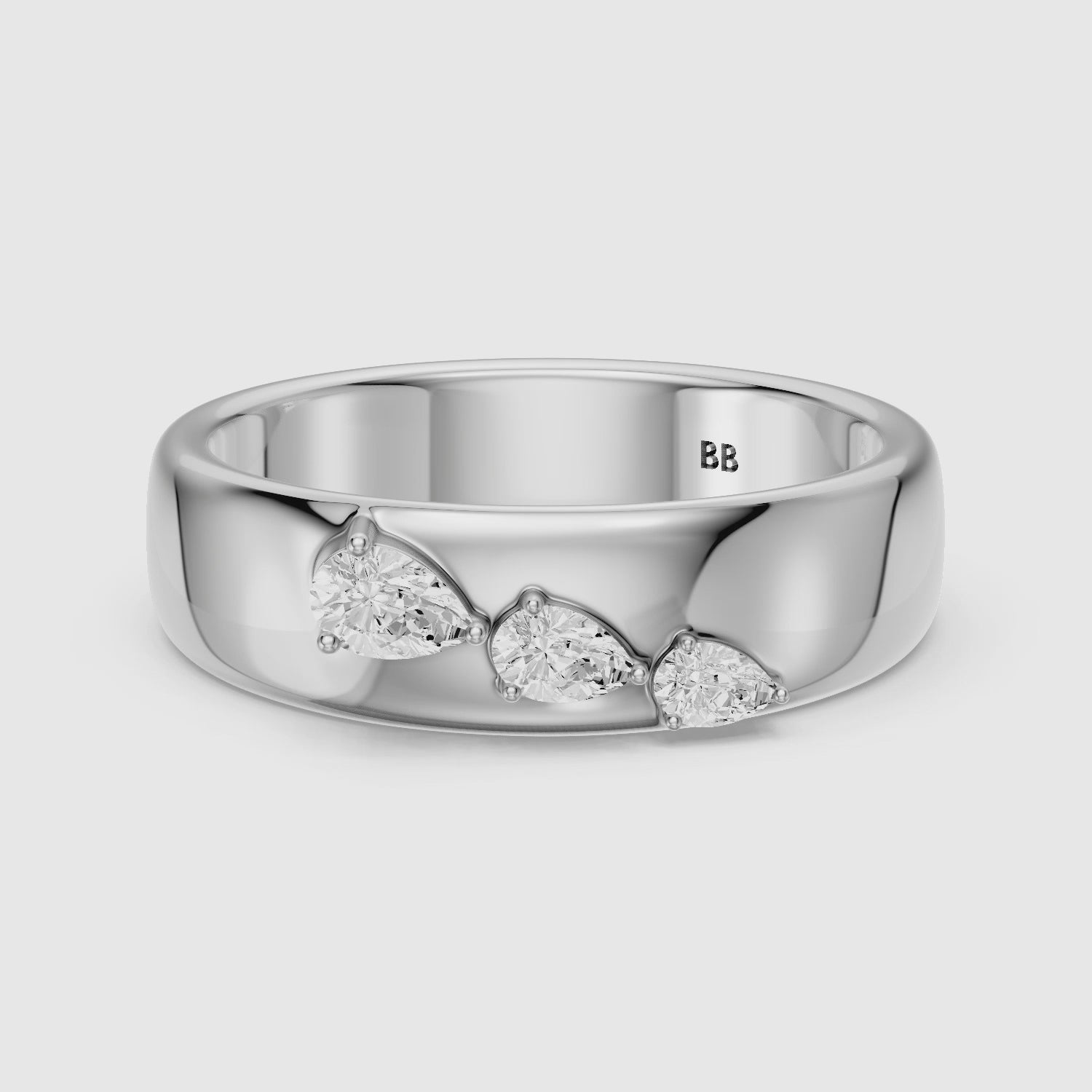 Load video: Britta Pear Cut Lab Diamond Graduated Three Stone Cigar Band