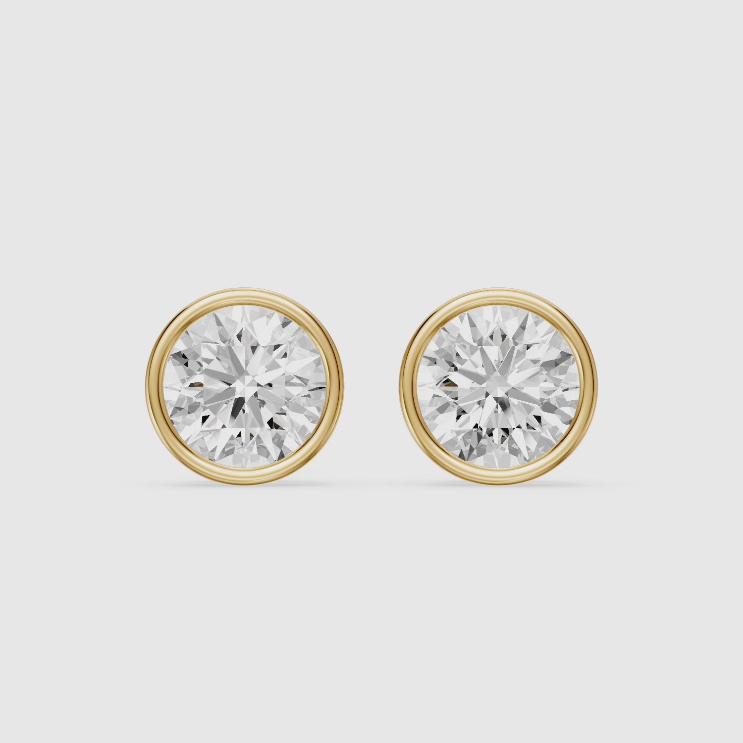 Load video: Lyra Round Cut Lab Grown Diamond Bezel Set Stud Earrings