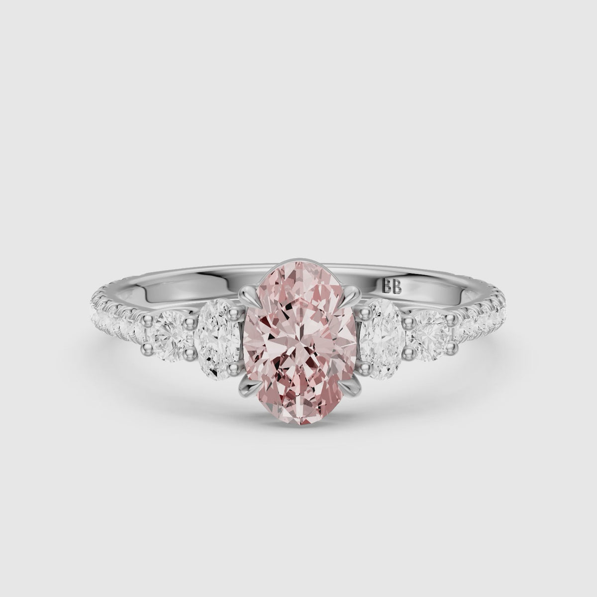 Load video: Eska Oval Cut Pink Lab Grown Diamond Ring with Oval and Round Side Diamonds