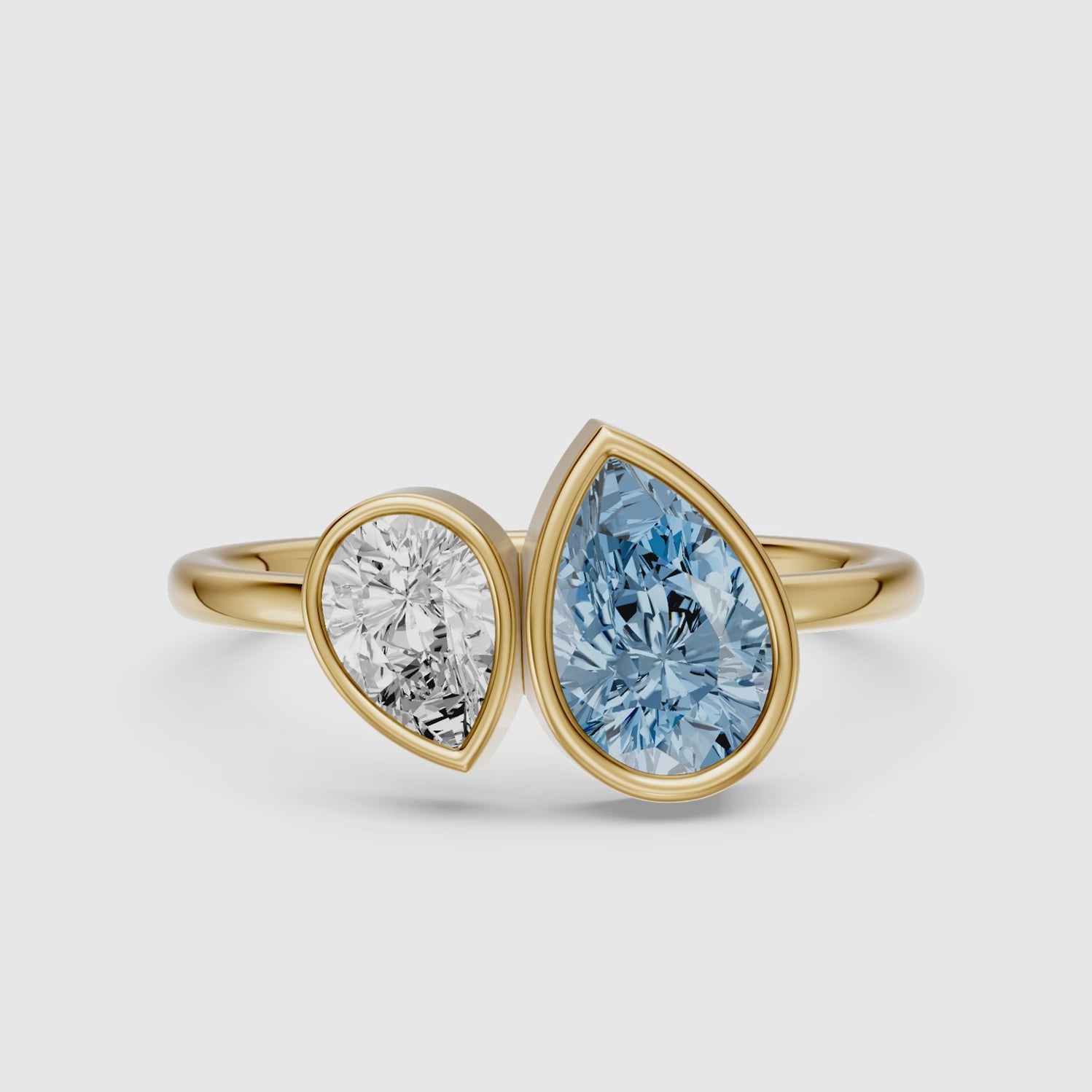 Load video: Nicolina Blue and White Pear Cut Colored Lab Grown Diamond Toi et Moi Bezel Ring