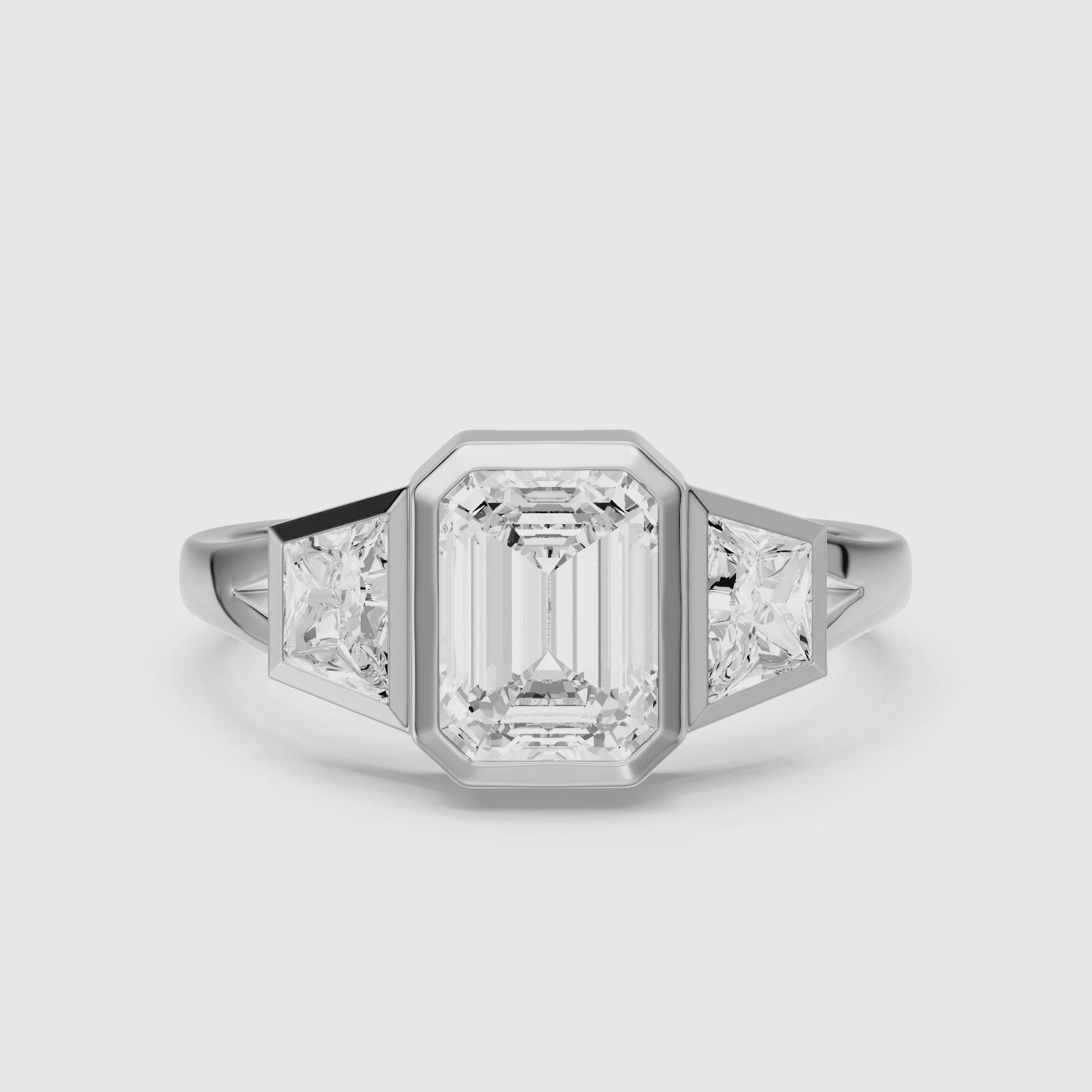 Load video: Stevie Emerald Cut Lab Grown Diamond Bezel Ring with Trapezoid Side Stones