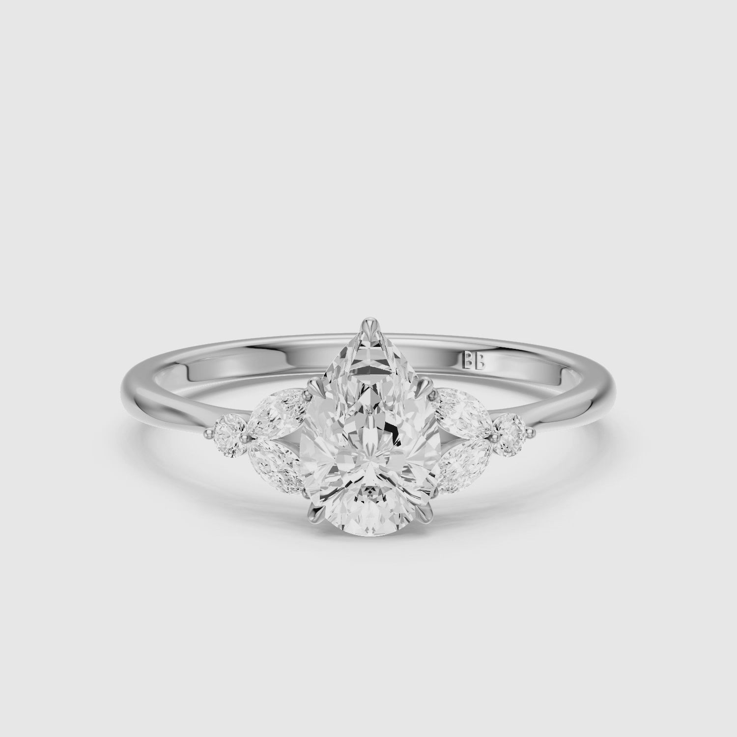 Load video: Liora Pear Cut Moissanite Diamond Ring with Marquise Side Stone Cluster