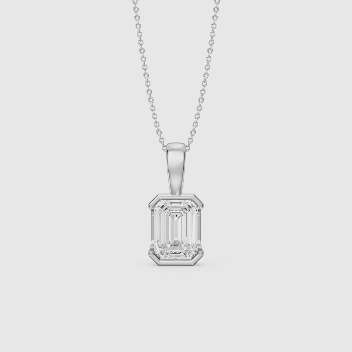 Load video: Catherine Emerald Cut Lab Grown Diamond Half Bezel Pendant
