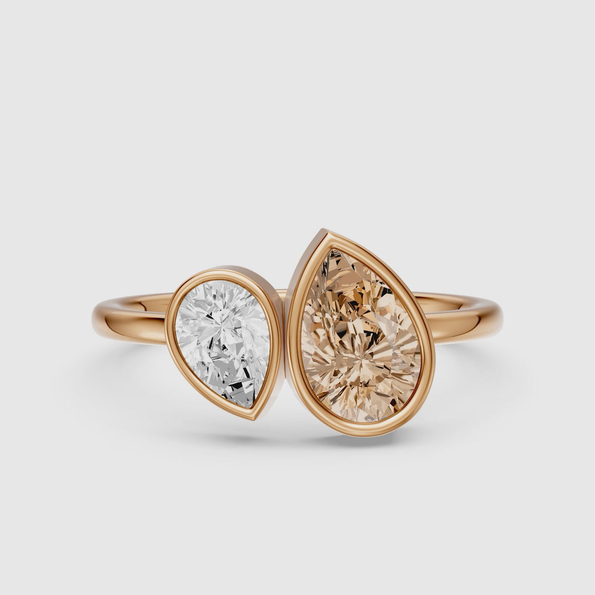 Load video: Ottilie Champagne and White Pear Cut Colored Lab Grown Diamond Toi et Moi Bezel Ring