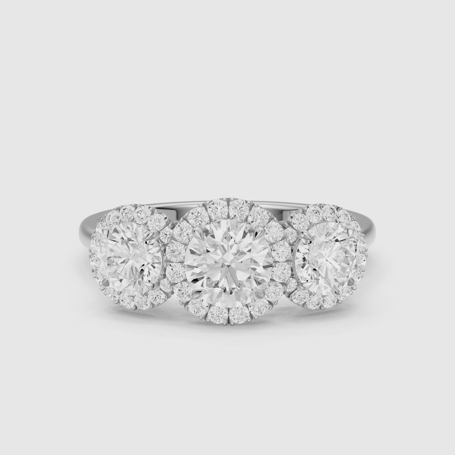 Load video: Ashley Three Stone Round Halo Lab Grown Diamond Ring