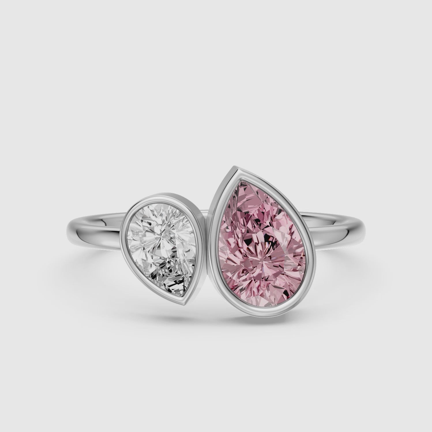 Load video: Prisca Pink and White Pear Cut Colored Lab Grown Diamond Toi et Moi Bezel Ring