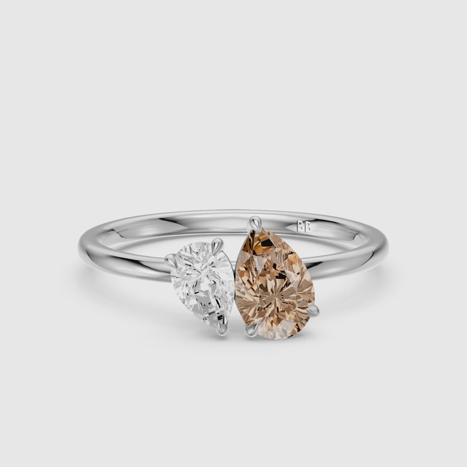 Load video: Fenna Champagne and White Graduated Pear Shape Color Lab Grown Diamond Toi et Moi Ring