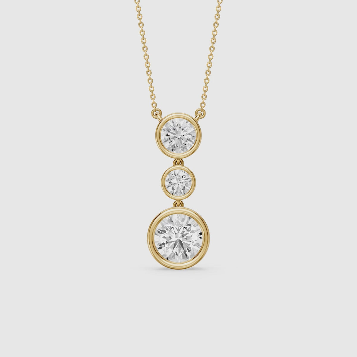 Load video: Esmeralda Three Stone Round Bezel Lab Grown Diamond Pendant