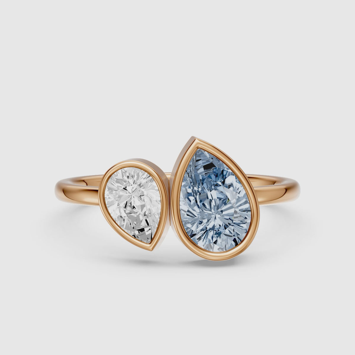 Load video: Nicolina Blue and White Pear Cut Colored Lab Grown Diamond Toi et Moi Bezel Ring