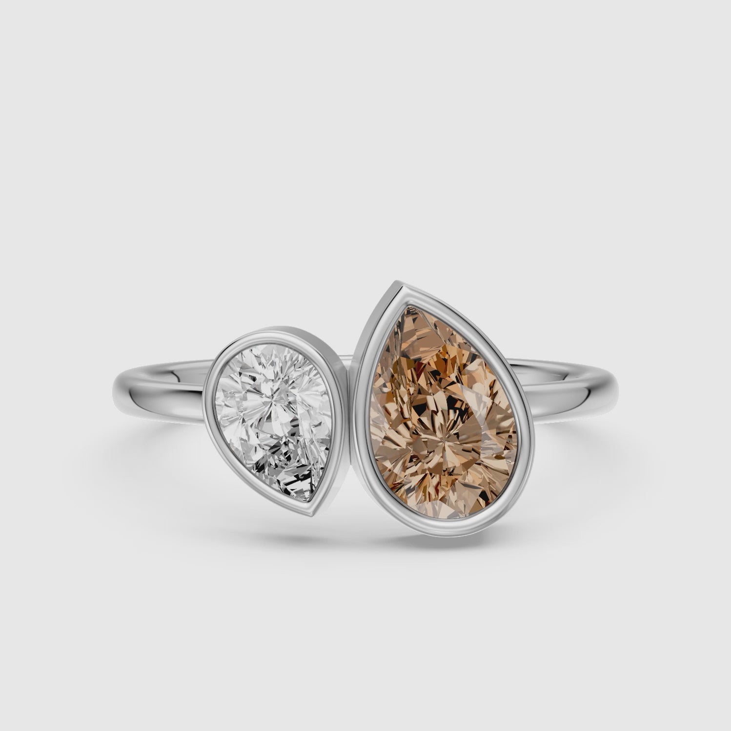Load video: Ottilie Champagne and White Pear Cut Colored Lab Grown Diamond Toi et Moi Bezel Ring