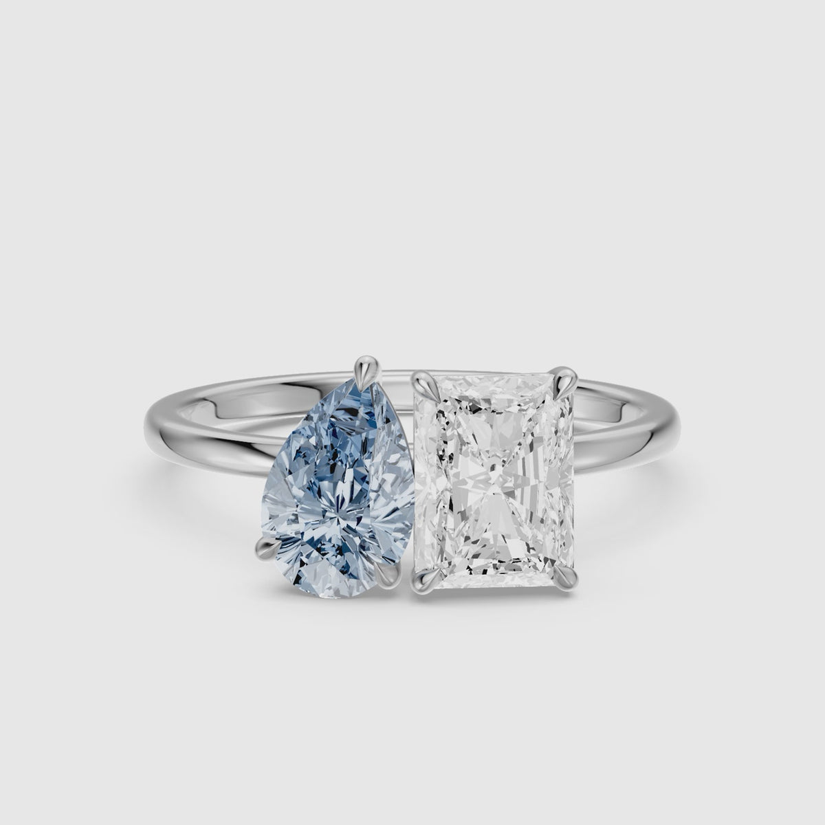 Load video: Eulalia Blue Pear and Radiant Cut Colored Lab Grown Diamond Toi et Moi Ring