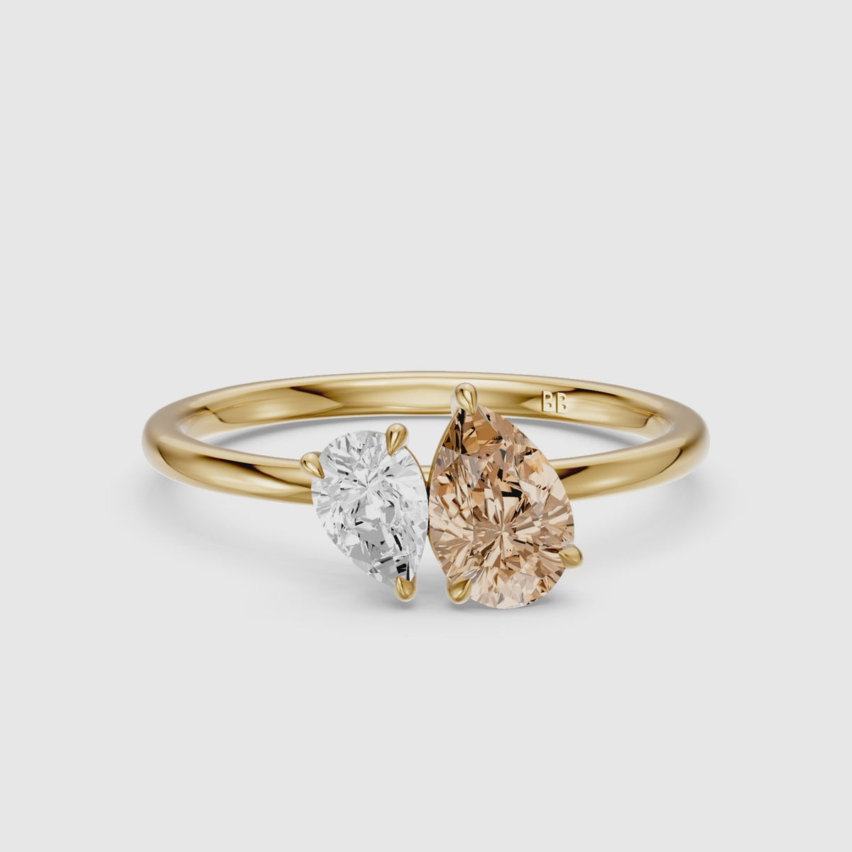 Load video: Fenna Champagne and White Graduated Pear Shape Color Lab Grown Diamond Toi et Moi Ring