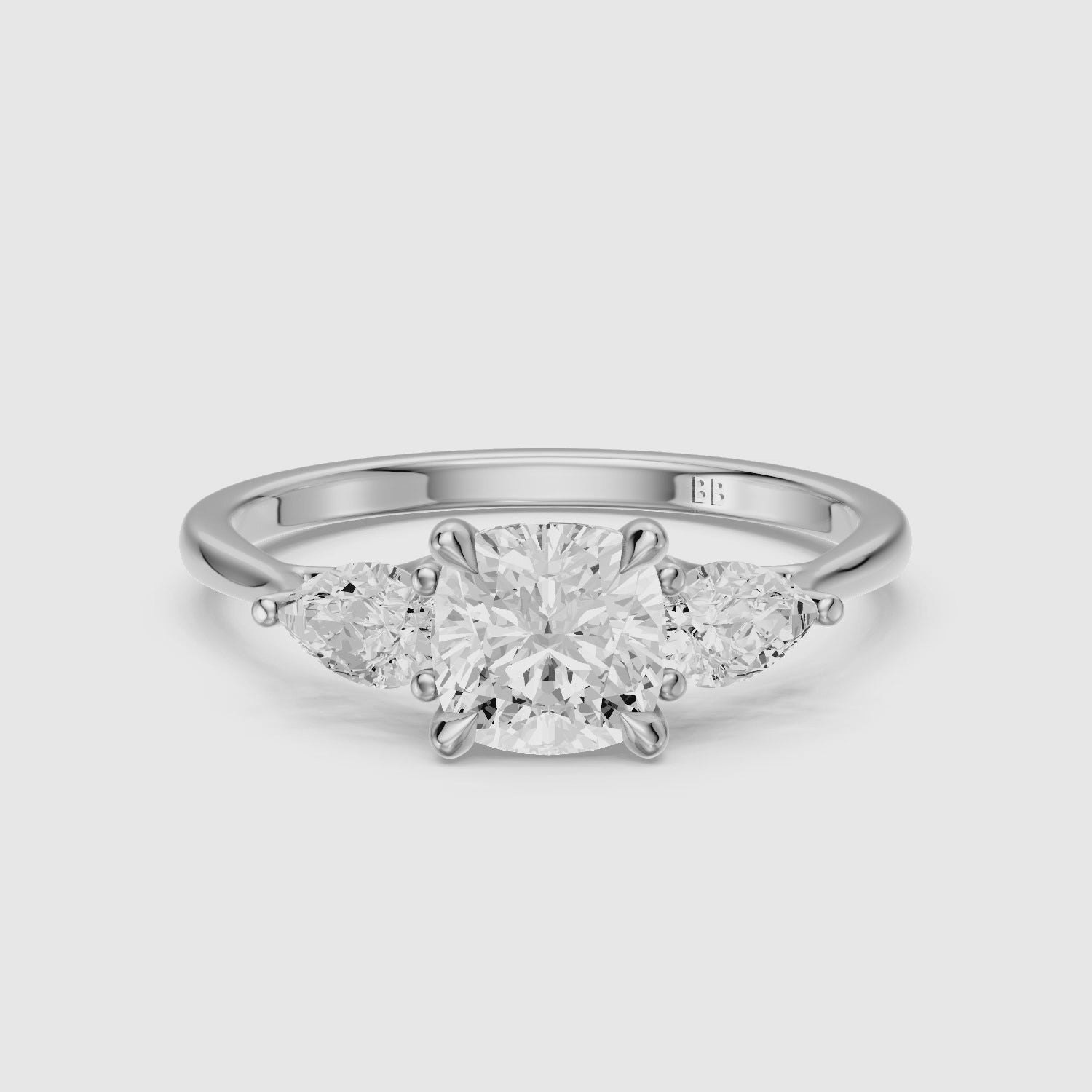 Load video: Meghan Three Stone Cushion With Pear Side Stones Moissanite Diamond Ring