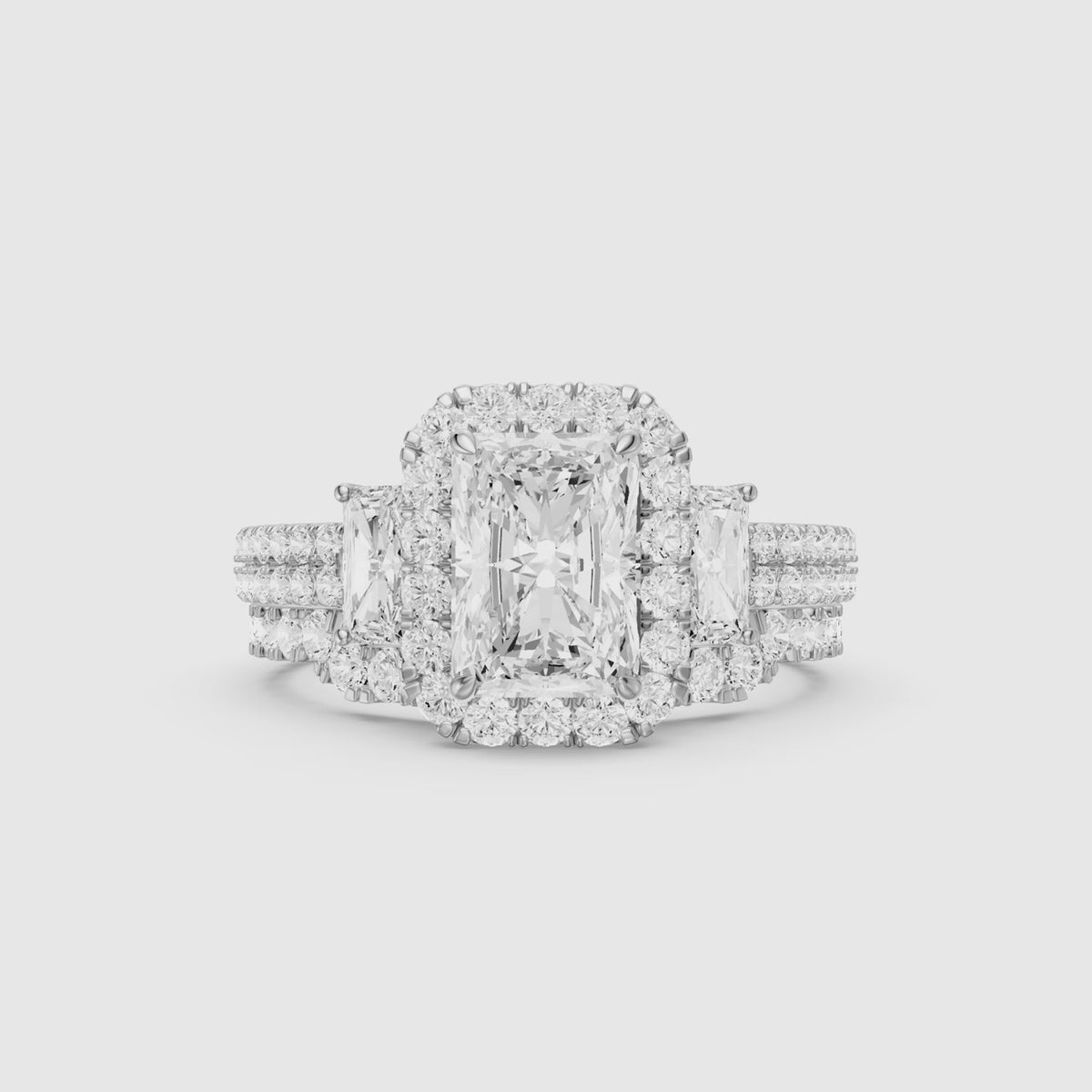 Load video: Seren Three Stone Radiant Cut Lab Grown Diamond Halo Bridal Set