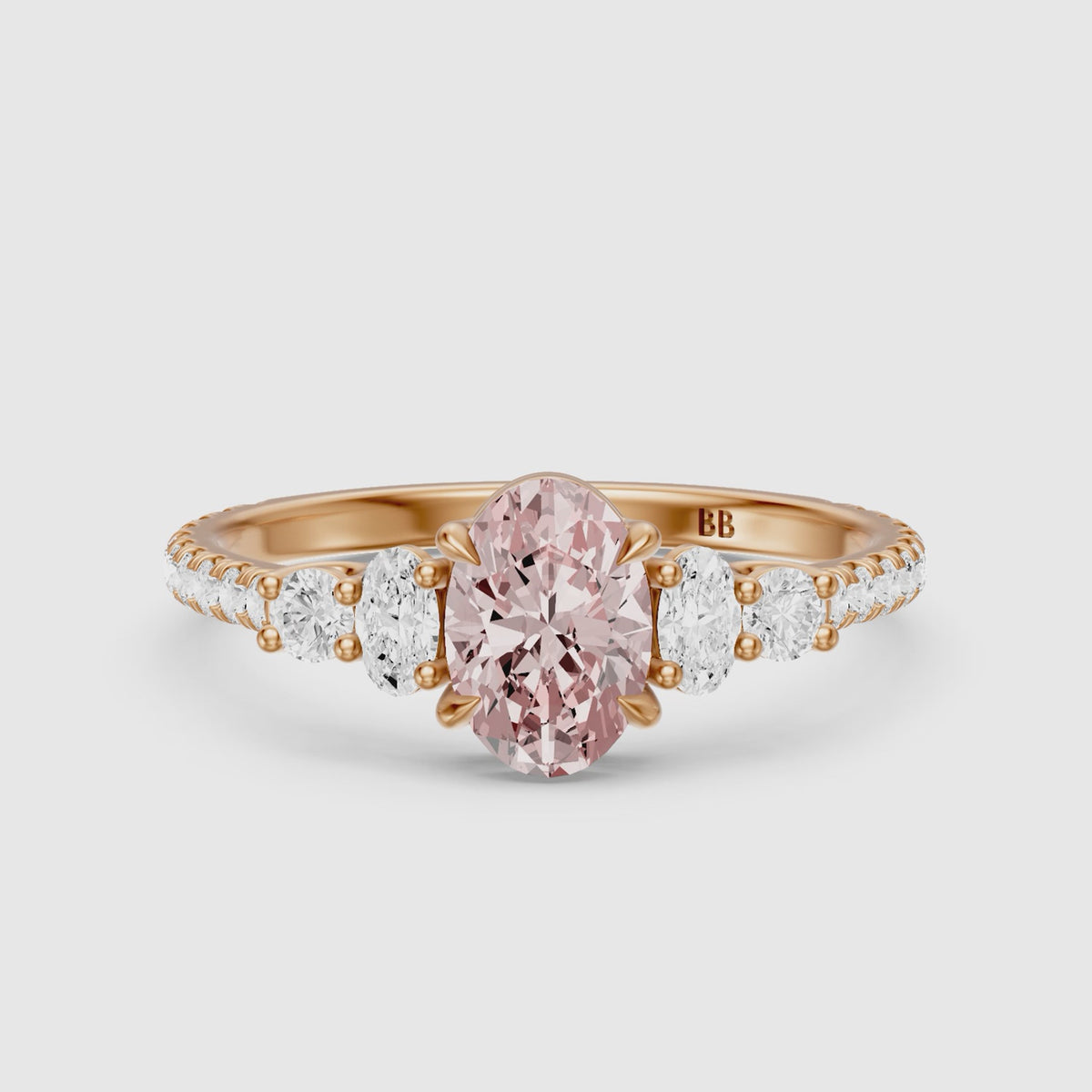 Load video: Eska Oval Cut Pink Lab Grown Diamond Ring with Oval and Round Side Diamonds