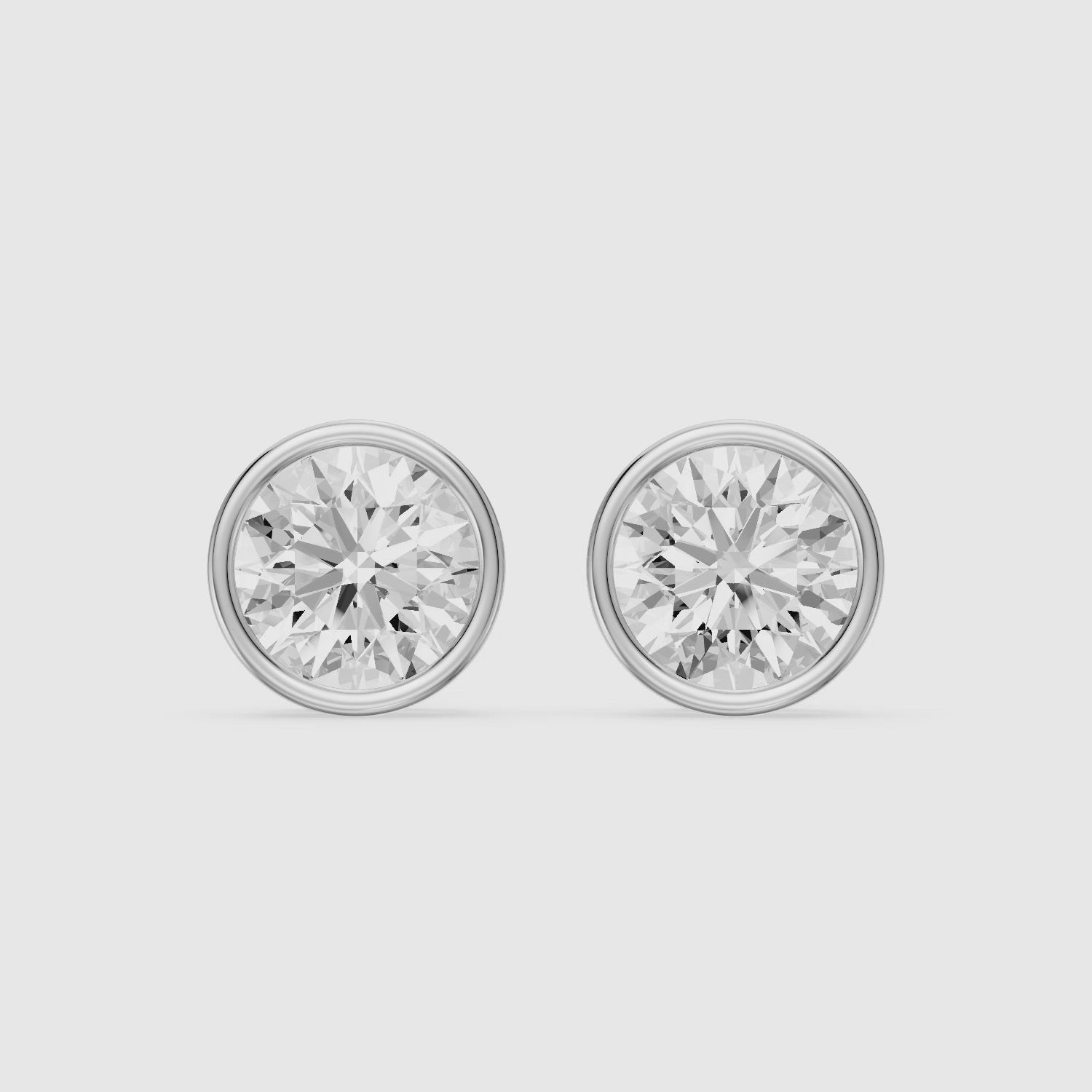 Load video: Meliora Round Cut Lab Grown Diamond Solitaire Bezel Stud Earrings