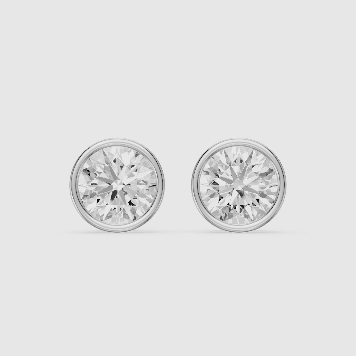 Load video: Lyra Round Cut Lab Grown Diamond Bezel Set Stud Earrings