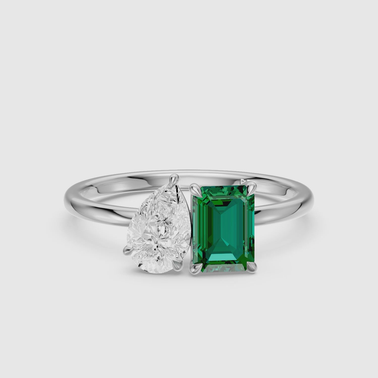 Load video: Belle Green Emerald Cut and Pear Shape Color Lab Grown Diamond Toi et Moi Ring