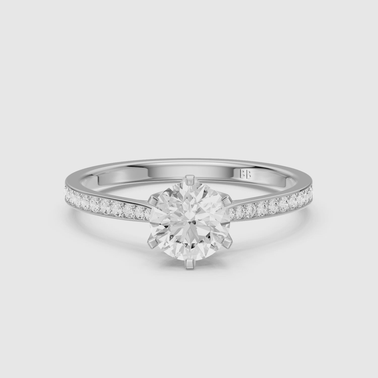 Load video: Desire 6 Prong Round Cut Side Stone Channel Set Moissanite Diamond Ring